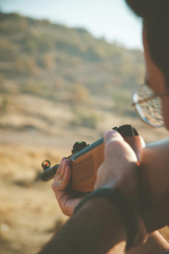A shooter lines up iron sights on his rifle.
