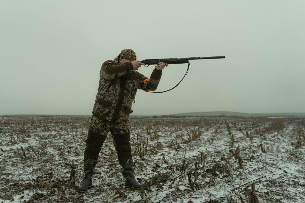 A hunter prepares to shoot his shotgun